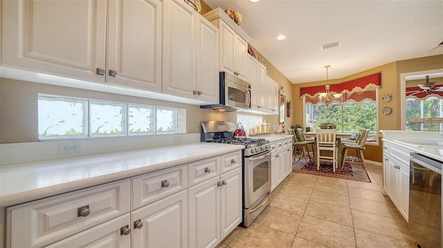 8183 Nice Way, Sarasota, FL 34238 - kitchen with appliances with stainless steel finishes, white cabinets, healthy amount of natural light, a chandelier, and recessed lighting