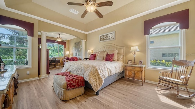 8183 Nice Way, Sarasota, FL 34238 - bedroom featuring decorative columns, light wood-style flooring, arched walkways, and ceiling fan