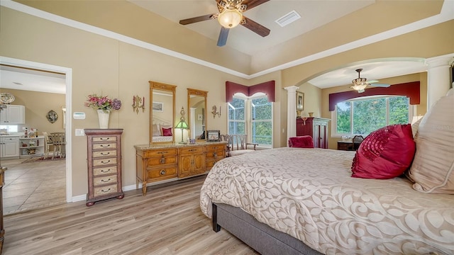 8183 Nice Way, Sarasota, FL 34238 - bedroom featuring decorative columns, arched walkways, light wood-type flooring, and ceiling fan