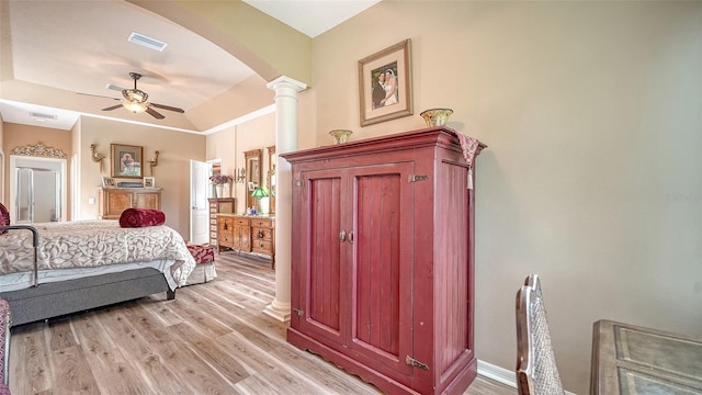 8183 Nice Way, Sarasota, FL 34238 - bedroom with arched walkways, light wood-style flooring, ornate columns, and a ceiling fan