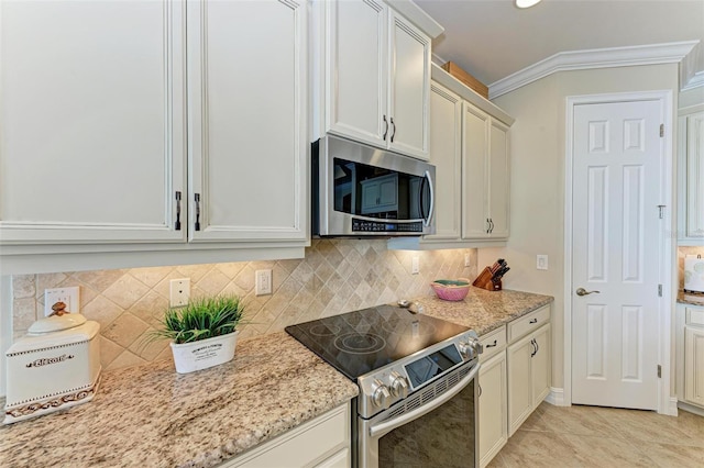 138 Toscavilla Blvd, Nokomis, FL 34275 - kitchen with stainless steel appliances, light stone countertops, backsplash, ornamental molding, and light tile patterned floors