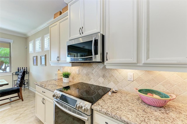 138 Toscavilla Blvd, Nokomis, FL 34275 - kitchen featuring appliances with stainless steel finishes, ornamental molding, backsplash, light stone counters, and white cabinetry
