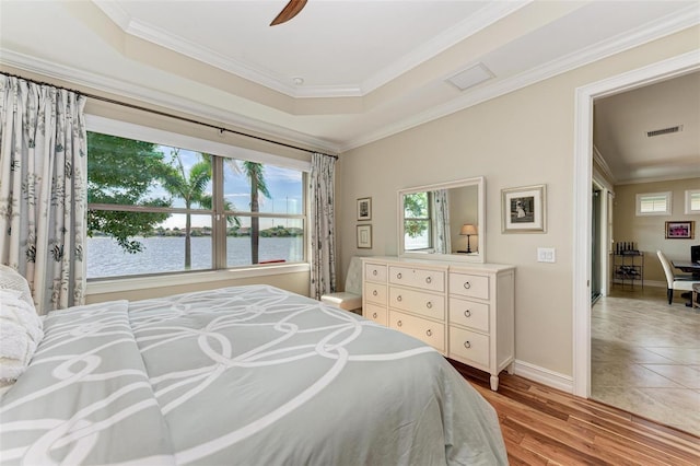 138 Toscavilla Blvd, Nokomis, FL 34275 - bedroom featuring multiple windows, a water view, ornamental molding, light wood-style flooring, and ceiling fan