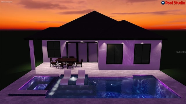 138 Toscavilla Blvd, Nokomis, FL 34275 - back of house at dusk featuring an in-ground hot tub, a patio area, and an outdoor pool