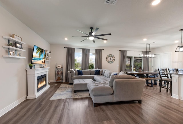 8985 Royal River Cir, Parrish, FL 34219 - living room featuring plenty of natural light, ceiling fan, dark wood-type flooring, recessed lighting, and a glass covered fireplace