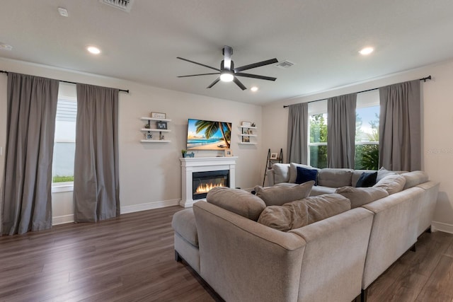8985 Royal River Cir, Parrish, FL 34219 - living area with ceiling fan, a glass covered fireplace, dark wood finished floors, and recessed lighting