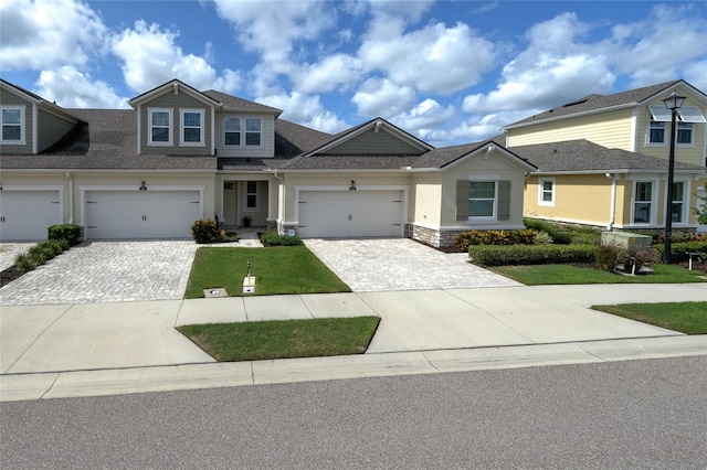 3681 Divot Ln, Sarasota, FL 34232 - view of front of home featuring decorative driveway, stucco siding, a front lawn, and roof with shingles