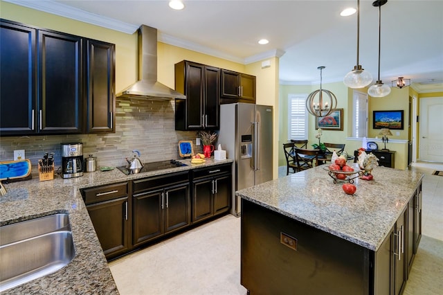 3681 Divot Ln, Sarasota, FL 34232 - kitchen with wall chimney range hood, black electric cooktop, high quality fridge, decorative backsplash, and ornamental molding