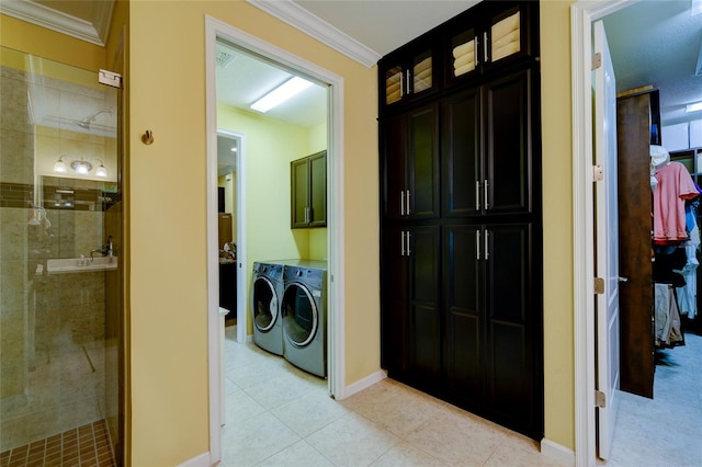 3681 Divot Ln, Sarasota, FL 34232 - washroom featuring washer and dryer, crown molding, light tile patterned floors, and cabinet space