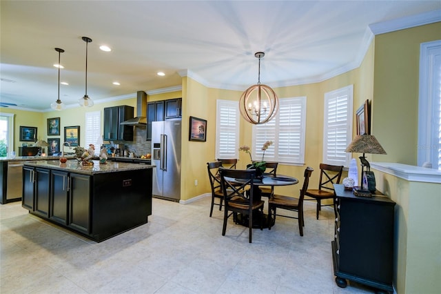 3681 Divot Ln, Sarasota, FL 34232 - kitchen with appliances with stainless steel finishes, a chandelier, wall chimney range hood, a kitchen island, and hanging light fixtures