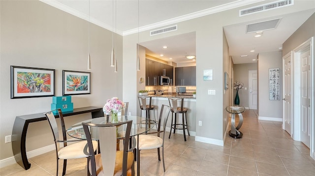 1771 Ringling Blvd Unit 1206, Sarasota, FL 34236 - dining area featuring light tile patterned floors and crown molding