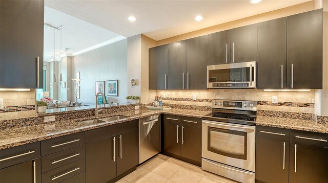 1771 Ringling Blvd Unit 1206, Sarasota, FL 34236 - kitchen with stainless steel appliances, ornamental molding, stone countertops, decorative backsplash, and recessed lighting