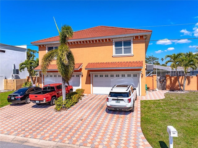 2119-2125 Montclair Dr Unit 2119 & 2125, Sarasota, FL 34231 - mediterranean / spanish-style home featuring a tiled roof, decorative driveway, stucco siding, and a garage