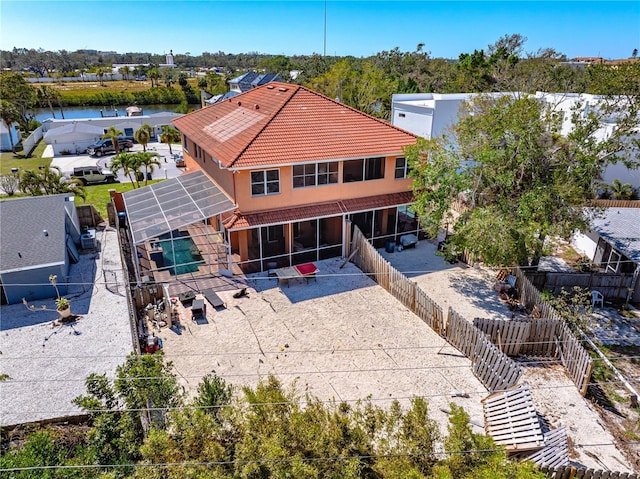 2119-2125 Montclair Dr Unit 2119 & 2125, Sarasota, FL 34231 - rear view of house with a patio, a fenced backyard, a sunroom, a tiled roof, and glass enclosure