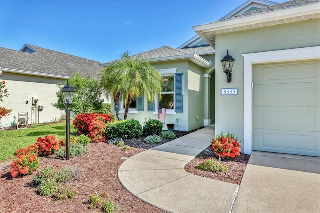 5333 Tide Point Way, Bradenton, FL 34208 - property entrance with stucco siding and an attached garage