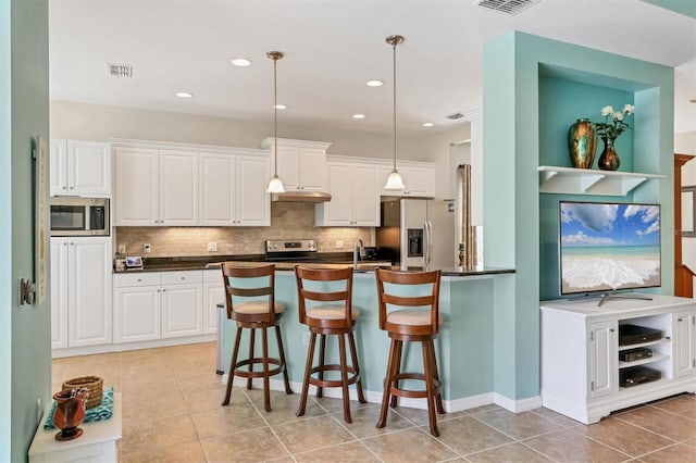 5333 Tide Point Way, Bradenton, FL 34208 - kitchen featuring stainless steel appliances, dark countertops, a breakfast bar area, pendant lighting, and recessed lighting