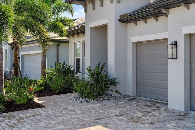 17737 Savory Mist Cir, Bradenton, FL 34211 - property entrance featuring stucco siding, a garage, and decorative driveway