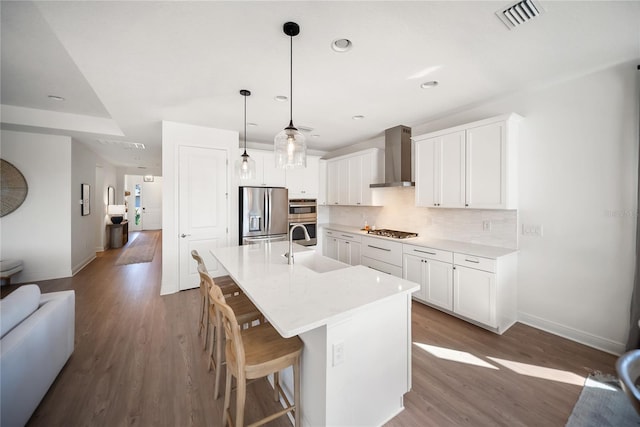 17737 Savory Mist Cir, Bradenton, FL 34211 - kitchen featuring appliances with stainless steel finishes, wall chimney exhaust hood, dark wood-type flooring, decorative backsplash, and recessed lighting