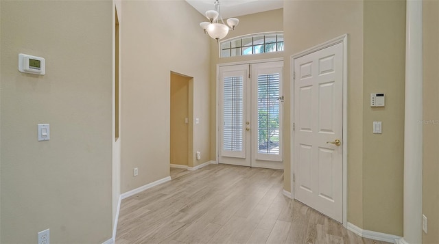 7717 US Open Loop, Lakewood Ranch, FL 34202 - foyer entrance with light wood-style floors and a chandelier