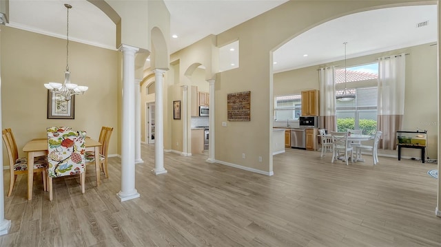 7717 US Open Loop, Lakewood Ranch, FL 34202 - dining area with a chandelier, a high ceiling, light wood-style floors, recessed lighting, and ornamental molding