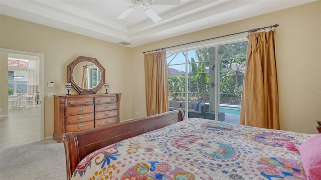 7717 US Open Loop, Lakewood Ranch, FL 34202 - carpeted bedroom with access to exterior, a tray ceiling, and ceiling fan