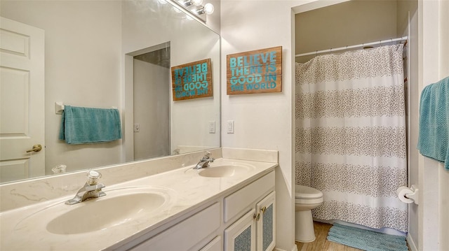 7717 US Open Loop, Lakewood Ranch, FL 34202 - full bathroom featuring double vanity, a shower with shower curtain, and wood finished floors