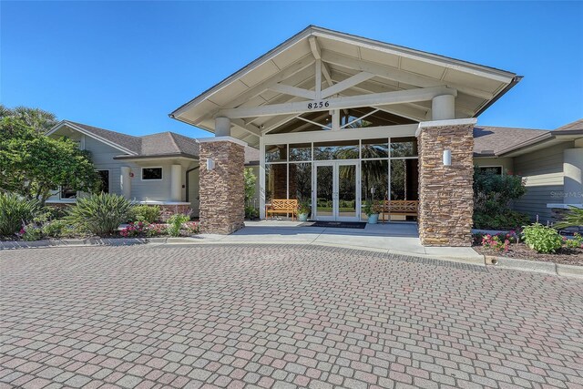 7717 US Open Loop, Lakewood Ranch, FL 34202 - doorway to property with french doors and stone siding