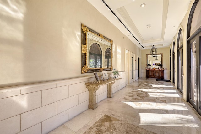 7717 US Open Loop, Lakewood Ranch, FL 34202 - corridor featuring inlaid floor details, wainscoting, a raised ceiling, and recessed lighting