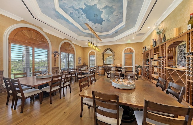 7717 US Open Loop, Lakewood Ranch, FL 34202 - dining space featuring wood finished floors, ornamental molding, and a raised ceiling