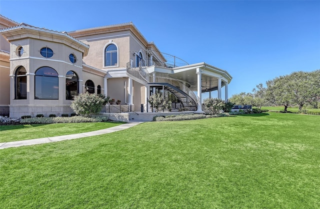 7717 US Open Loop, Lakewood Ranch, FL 34202 - rear view of property with stairway and a yard
