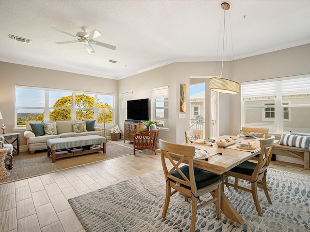 7840 34th Ave W Unit 303, Bradenton, FL 34209 - dining area featuring a ceiling fan, crown molding, light wood-type flooring, and a textured ceiling