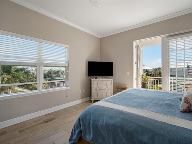7840 34th Ave W Unit 303, Bradenton, FL 34209 - bedroom with access to outside, ornamental molding, and wood finished floors