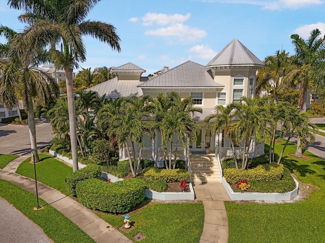 7840 34th Ave W Unit 303, Bradenton, FL 34209 - coastal inspired home featuring a metal roof, a front lawn, a standing seam roof, a porch, and stucco siding