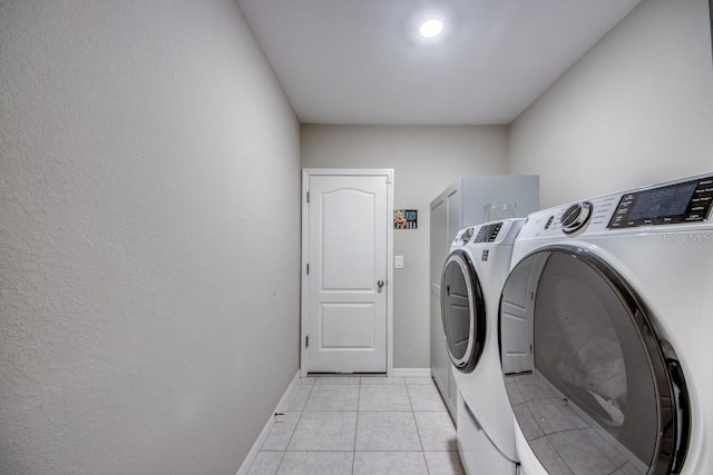 640 Encarnacion St, Punta Gorda, FL 33983 - laundry room with washer and clothes dryer and light tile patterned flooring