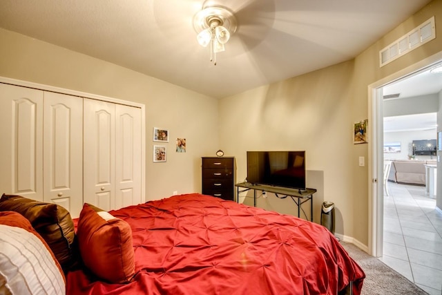 640 Encarnacion St, Punta Gorda, FL 33983 - bedroom with light tile patterned flooring, a closet, a ceiling fan, and light carpet