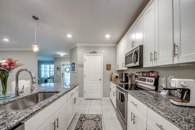 640 Encarnacion St, Punta Gorda, FL 33983 - kitchen featuring appliances with stainless steel finishes, ornamental molding, white cabinets, hanging light fixtures, and light tile patterned floors
