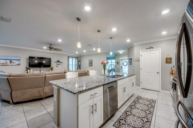 640 Encarnacion St, Punta Gorda, FL 33983 - kitchen featuring stainless steel appliances, crown molding, an island with sink, light stone countertops, and decorative light fixtures