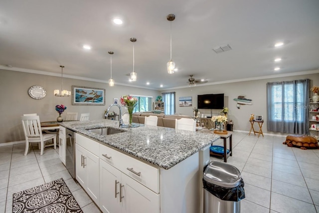 640 Encarnacion St, Punta Gorda, FL 33983 - kitchen featuring ornamental molding, light tile patterned floors, an island with sink, stainless steel dishwasher, and plenty of natural light
