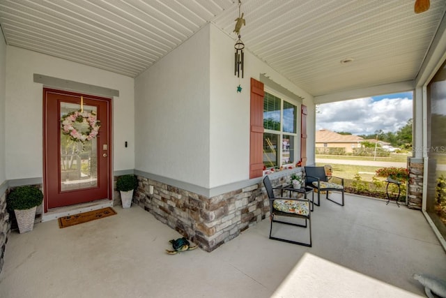 640 Encarnacion St, Punta Gorda, FL 33983 - doorway to property with covered porch, stone siding, and stucco siding