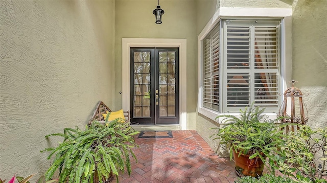 7012 Treymore Ct, Sarasota, FL 34243 - view of exterior entry featuring french doors and stucco siding