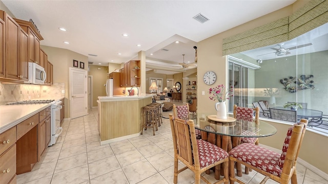 7012 Treymore Ct, Sarasota, FL 34243 - dining area with a ceiling fan, light tile patterned floors, and recessed lighting