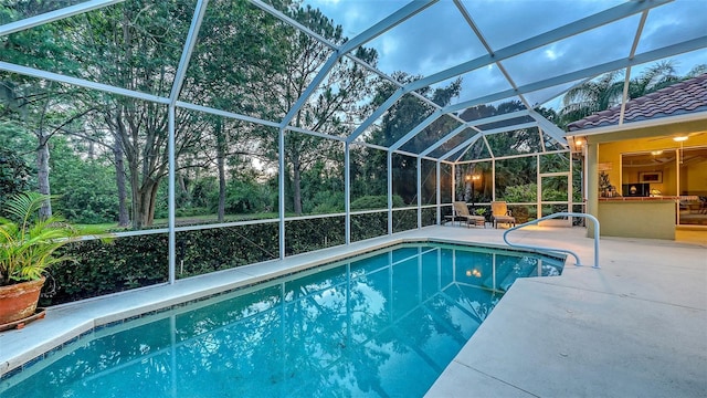 7012 Treymore Ct, Sarasota, FL 34243 - swimming pool featuring a patio and glass enclosure