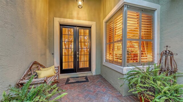 7012 Treymore Ct, Sarasota, FL 34243 - view of exterior entry with stucco siding and french doors