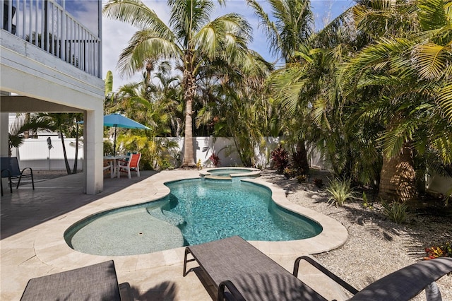 123 52nd St Unit B, Bradenton Beach, FL 34217 - view of pool featuring a patio area, a fenced backyard, and a pool with connected hot tub