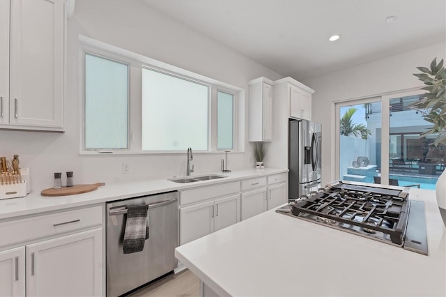 6028 Red Mangrove Ln, Bradenton, FL 34210 - kitchen with stainless steel appliances, white cabinets, light countertops, and recessed lighting