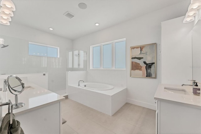 6028 Red Mangrove Ln, Bradenton, FL 34210 - full bath featuring two vanities, a garden tub, walk in shower, tile patterned floors, and recessed lighting