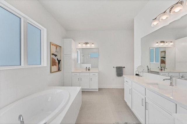 6028 Red Mangrove Ln, Bradenton, FL 34210 - bathroom featuring a bath, two vanities, a walk in shower, and tile patterned floors