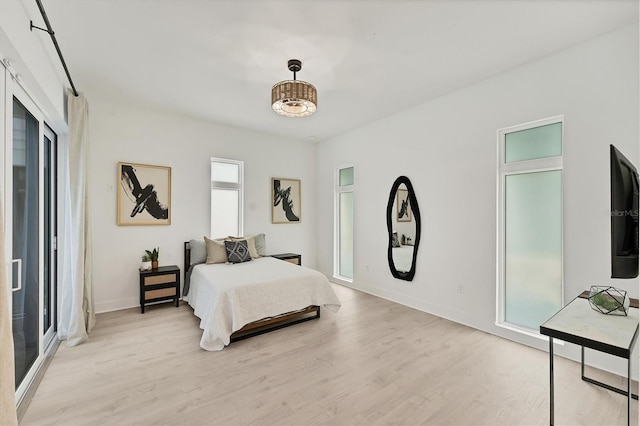6028 Red Mangrove Ln, Bradenton, FL 34210 - bedroom with light wood-type flooring and baseboards