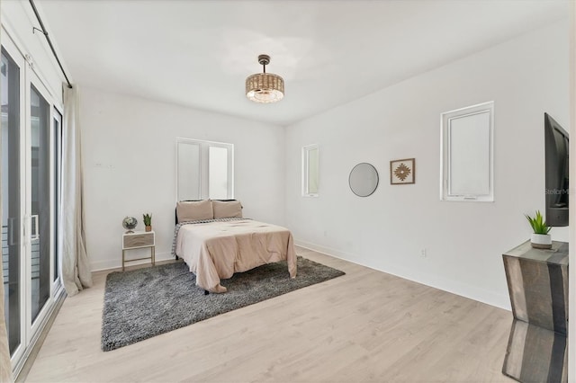6028 Red Mangrove Ln, Bradenton, FL 34210 - bedroom with light wood finished floors and baseboards