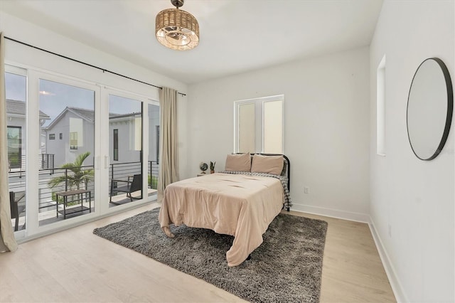 6028 Red Mangrove Ln, Bradenton, FL 34210 - bedroom featuring wood finished floors and access to outside